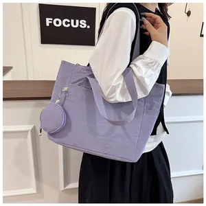 Detail of purple nylon tote bag with small matching round zipper coin purse
