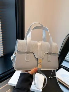 Elegant silver handbag with rhinestone details and gold twist lock for women