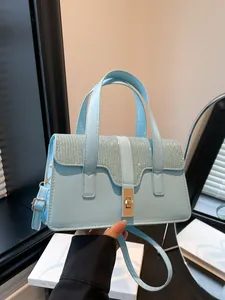 Light blue faux leather handbag with sparkling rhinestone flap and golden lock