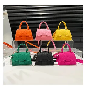 Detailed arrangement of mini hourglass handbags in various bright colors with quilted patterns