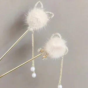 Golden Chinese hair sticks with white pom-poms, long tassels, rhinestones and pearls