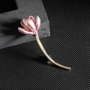 Exquisite pink lotus flower brooch with purple enamel petals and gold stems on dark background