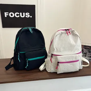 Minimalist lightweight nylon backpack in black and beige with vibrant contrast zippers