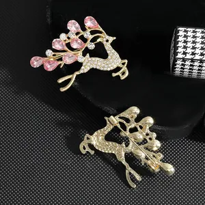 Elegant deer brooch with pink opal and rhinestones, front and back views on black velvet