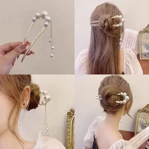U-shaped golden hair pin with white pearls and long metal tassels in retro style