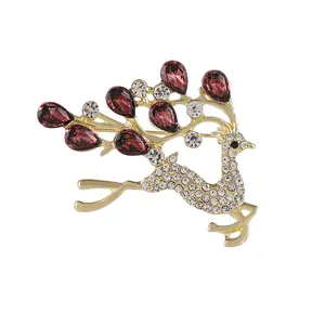 Elegant gold deer brooch with white rhinestones and red opal teardrop antlers