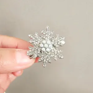 Close-up of snowflake hair clip with shiny rhinestones and small white pearls