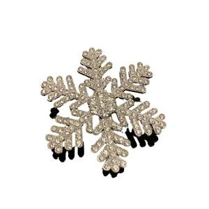 Sparkling snowflake hair clip with rhinestones in silver finish on a black mirror base