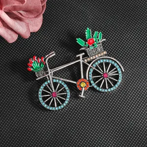 Vintage bicycle brooch with green enamel cactus and multi-color rhinestones on black