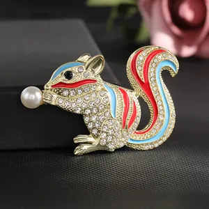 Detail of squirrel brooch with rhinestones, colorful enamel and a white pearl accent