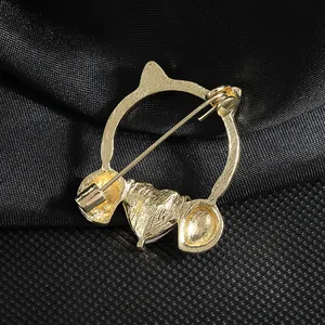 Cat ear heart crystal headphone brooch in gold plating showing back pin detail