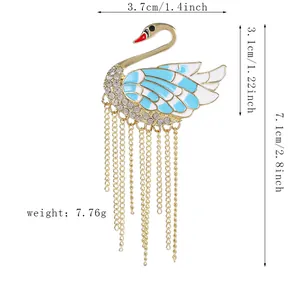 Detail showing swan brooch dimensions with blue enamel, crystals and gold tassels