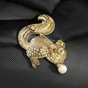 Back view of vintage gold squirrel brooch with alloy texture and pearl detail