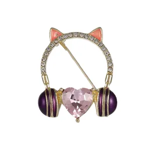 Elegant cat-ear headphone brooch featuring a pink heart crystal and sparkling rhinestones
