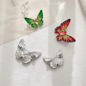 Elegant butterfly brooches featuring colorful enamel gradients and sparkling crystal accents