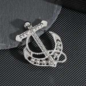 Detailed back view of a silver anchor brooch with sparkling rhinestones and secure pin clasp