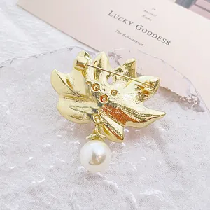 Broche feuille de lotus dorée avec perle, vue arrière montrant le fermoir à épingle