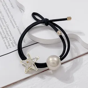 Close-up of double-strand hair tie with sparkling rhinestone starfish and faux pearl
