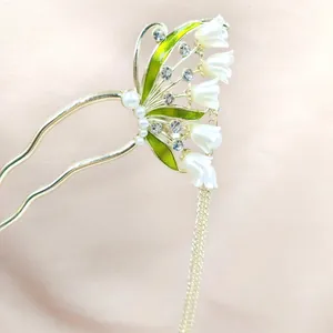 Horquilla en forma de U con lirio de los valles dorado, perlas y borla elegante