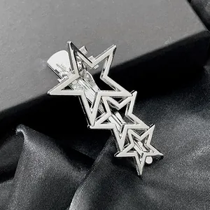 Silver minimalist hollow star hair clip set on black satin background for women