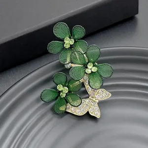 Elegant emerald mesh flower brooch with golden butterfly and sparkling rhinestones