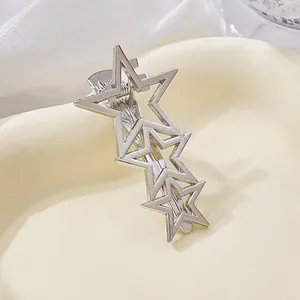 Close-up of three interlocking silver hollow star hairpins with a polished metal finish