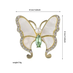 Detail der Schmetterlingsbrosche mit grünem Edelstein, Perle und Strass-Akzenten