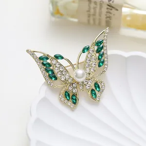 Exquisite gold butterfly brooch with green gems, rhinestones and center pearl on shell