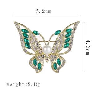 Detailed dimensions of green rhinestone butterfly brooch with pearl center and gold finish