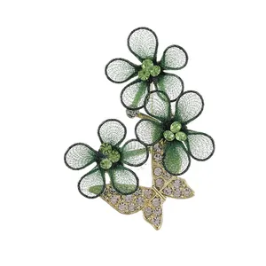 Elegant butterfly and green floral mesh brooch with sparkling rhinestones in gold finish