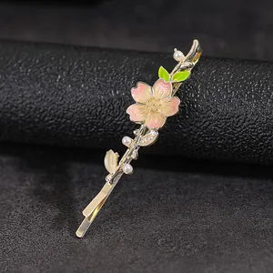 Elegant pink cherry blossom hair clip with gold metal finish and white pearls