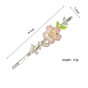 Detailed view showing a 6.1cm pink flower hair clip with green leaves and white pearls