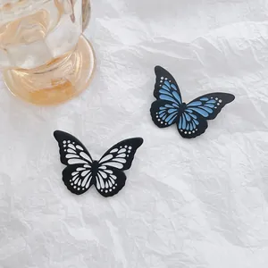 Set of two glowing butterfly brooches in blue and white with detailed wing textures