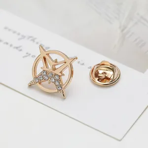 Detailed macro view of golden star-shaped lapel pin with clear crystals and butterfly clutch