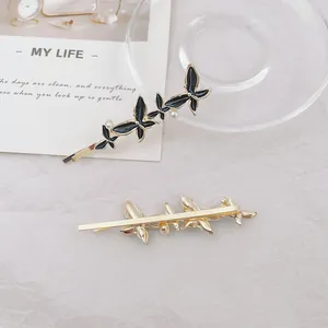 Exquisite goldene Schmetterlings-Haarklammern mit schwarzer Emaille und Perlen im 2er-Set