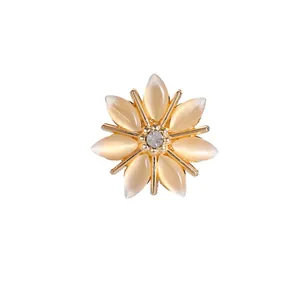 Champagne cat eye stone sunburst brooch with center crystal on gold base