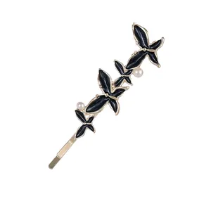 Eleganter goldener Schmetterling-Haarclip mit schwarzer Emaille und weißen Perlen