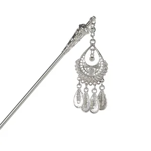 Ethnic Miao silver hair pin with hollow water drop pendant and tassels on white background
