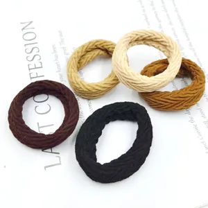 Detailed view of 5-piece earth tone elastic hair ties in woven knit texture and neutral colors