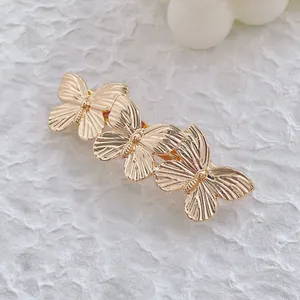 Barrette à cheveux papillon en métal doré au fini poli pour une coiffure élégante de femme