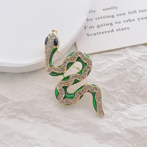 Close-up of green snake brooch with sparkling emerald enamel and crystal details
