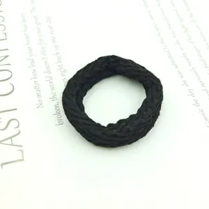 Close-up of thick black braided hair tie with high-elasticity textured knit design