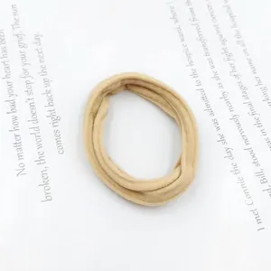 Close-up of beige high-elasticity seamless scrunchie with soft knitted fabric texture