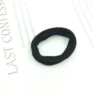 Detail of high-elastic black seamless scrunchie with soft velvet fabric texture