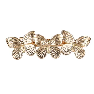 Barrette à cheveux minimaliste en métal doré avec trois papillons et pince à ressort