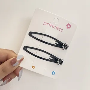 Juego de dos pinzas metálicas negras para el pelo con diseño floral de strass brillante