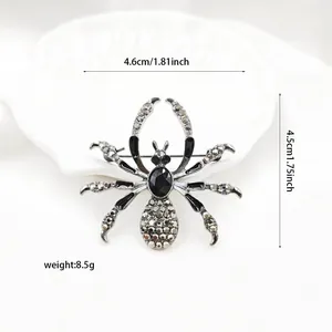 Macro detail of gothic spider brooch featuring dark grey rhinestones and silver finish