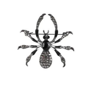 Gothic spider brooch in dark alloy with black gemstone and sparkling grey crystals