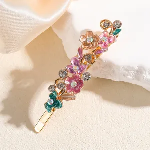 Fermaglio per capelli in lega dorata con fiori in smalto colorato e strass lucidi