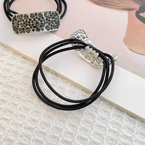 Elegant elastic ponytail holder with geometric rhinestones and luxury metal base detail